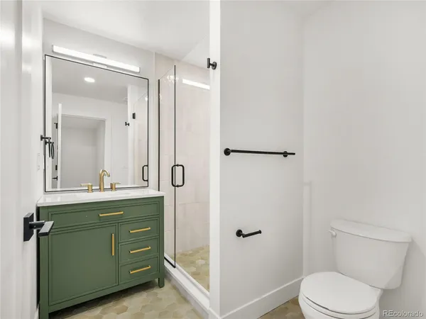 a bathroom with a toilet sink and shower