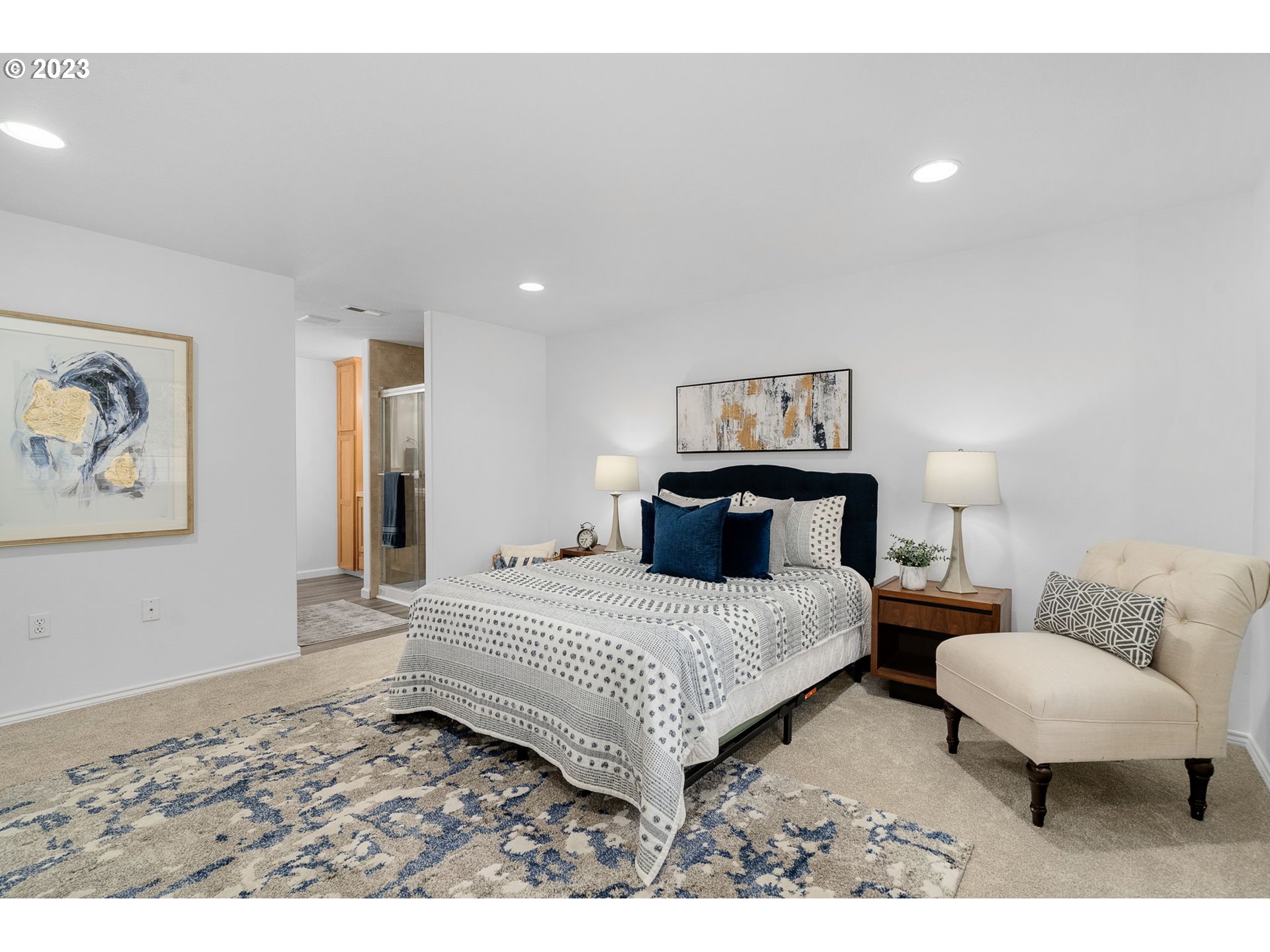 21055 South Ferguson Road Oregon City, OR 97045 - Photo 16 of 46 a spacious bedroom with a bed and a couch