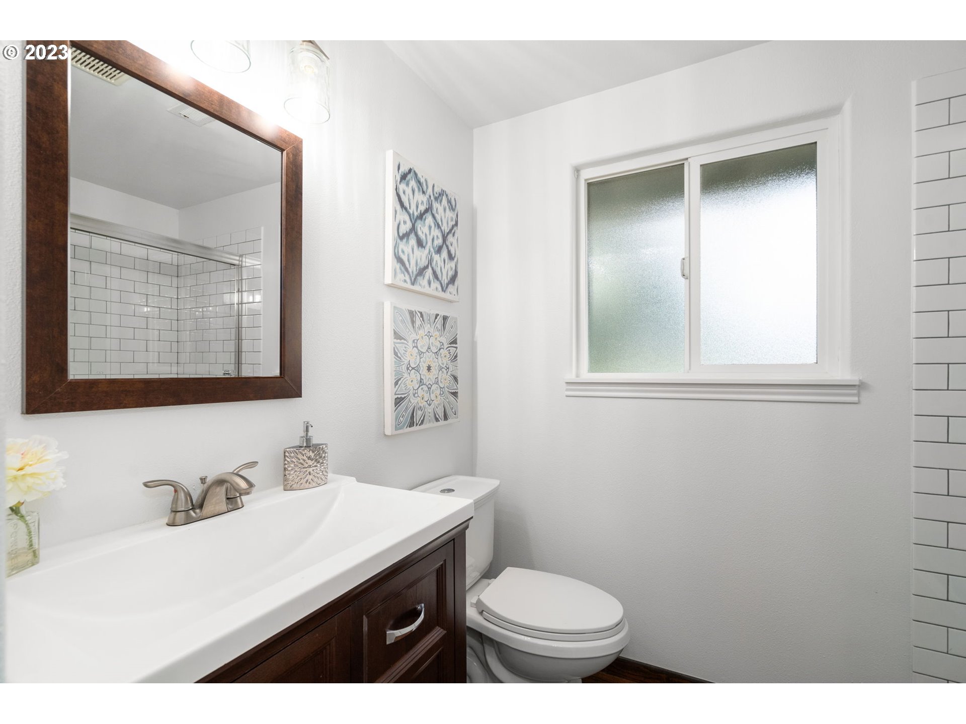 21055 South Ferguson Road Oregon City, OR 97045 - Photo 22 of 46 a bathroom with a sink toilet a mirror and vanity