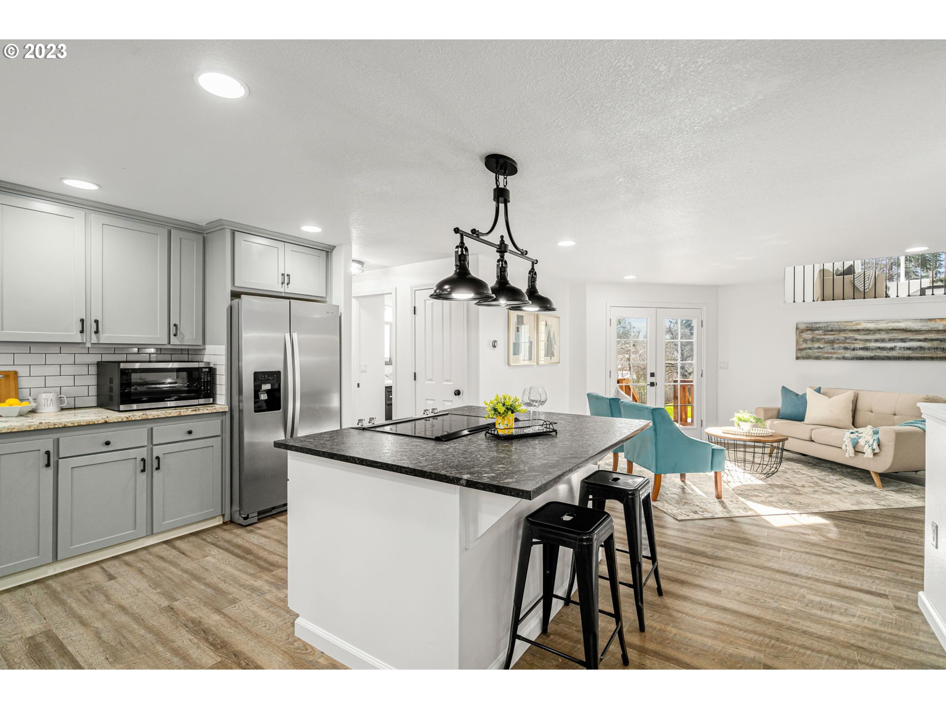 21055 South Ferguson Road Oregon City, OR 97045 - Photo 6 of 46 a kitchen with a table chairs refrigerator and cabinets