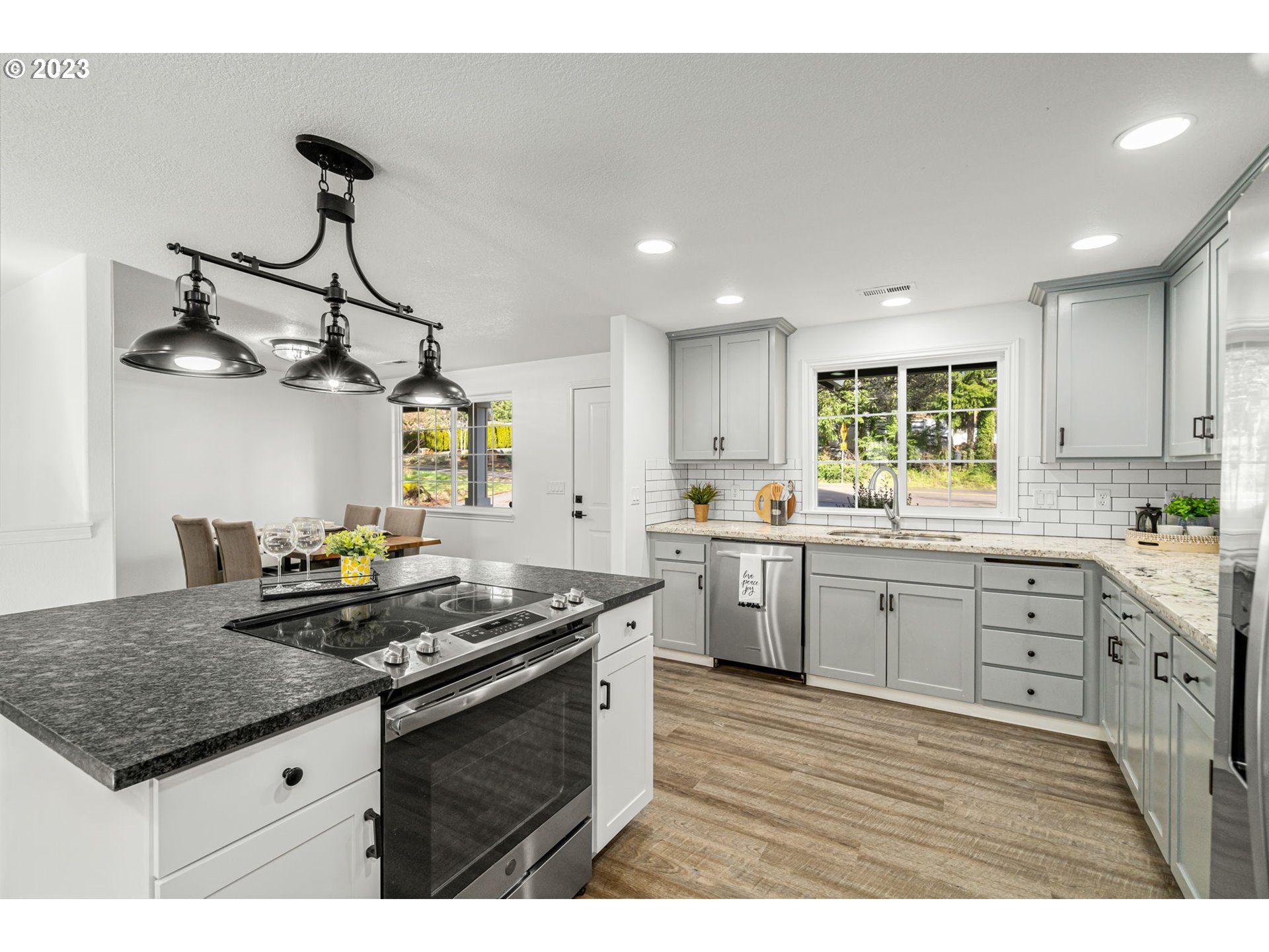 21055 South Ferguson Road Oregon City, OR 97045 - Photo 8 of 46 a kitchen with stainless steel appliances granite countertop a sink a stove and a wooden floors