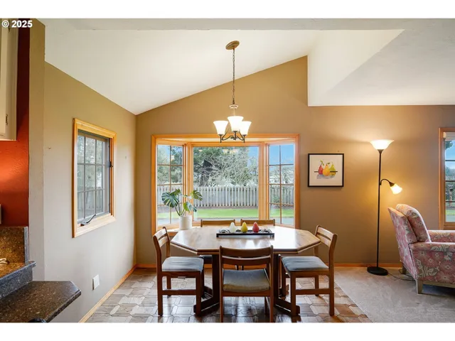 a view of a dining room with furniture window and outside view