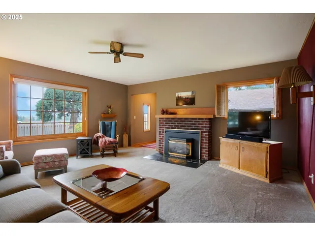 a living room with furniture a fireplace and a flat screen tv