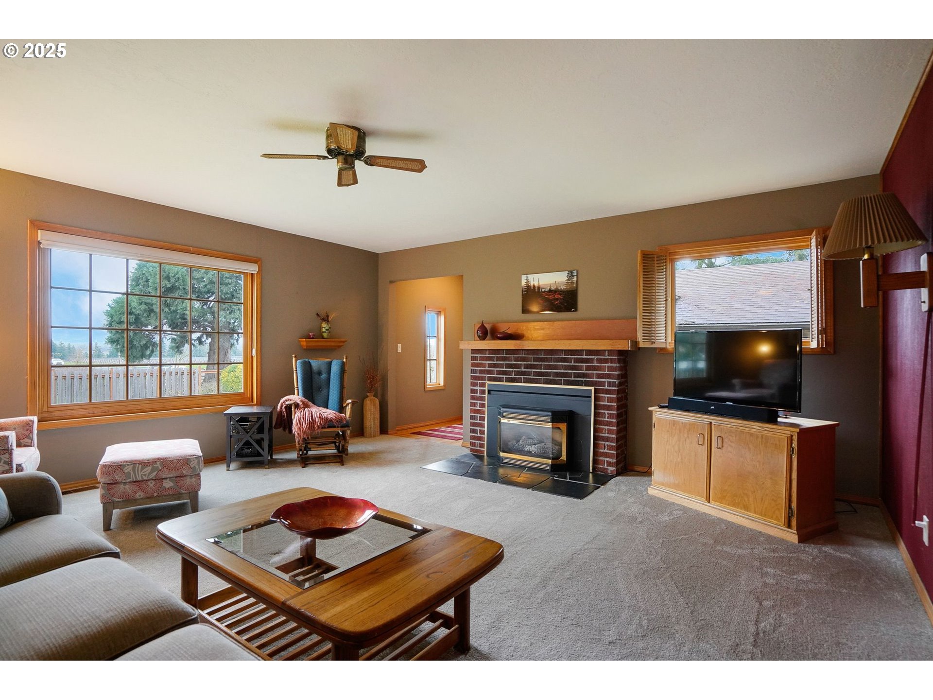 11515 Buena Vista Road Independence, OR 97351 - Photo 19 of 45 a living room with furniture a fireplace and a flat screen tv