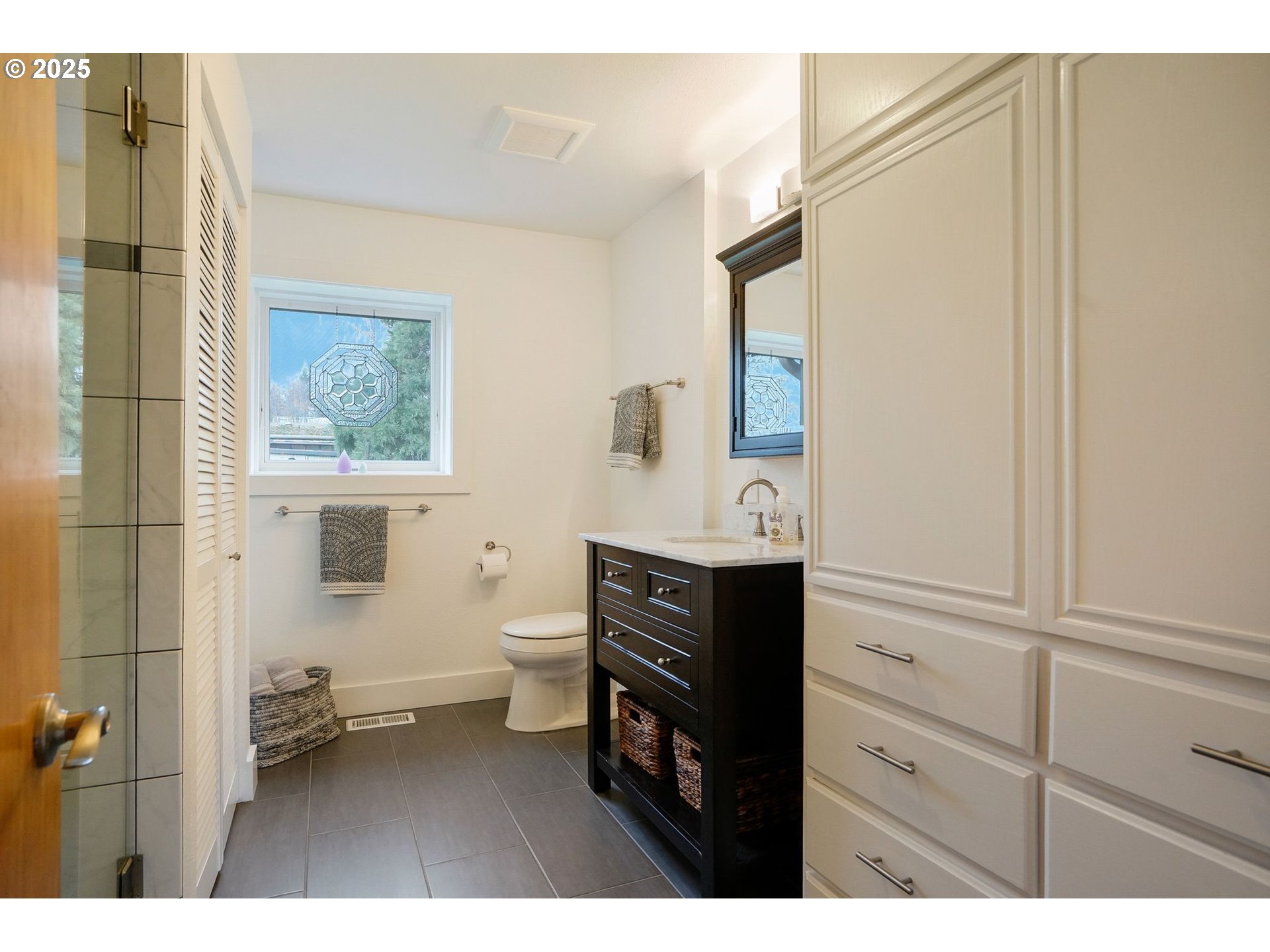 11515 Buena Vista Road Independence, OR 97351 - Photo 23 of 45 a bathroom with a sink a mirror and a toilet