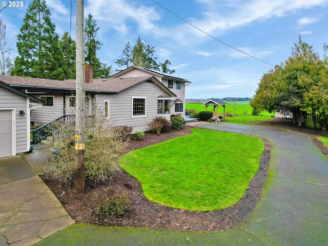 a view of a house with a backyard and porch