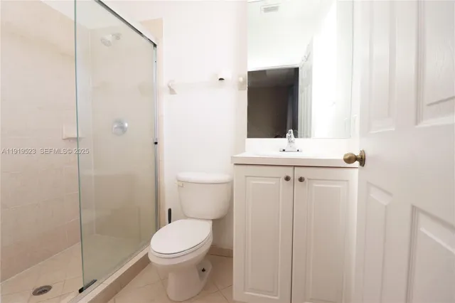 a bathroom with a toilet sink and shower