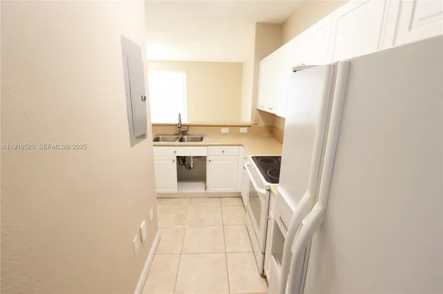 a kitchen with a refrigerator a stove top oven and a dishwasher