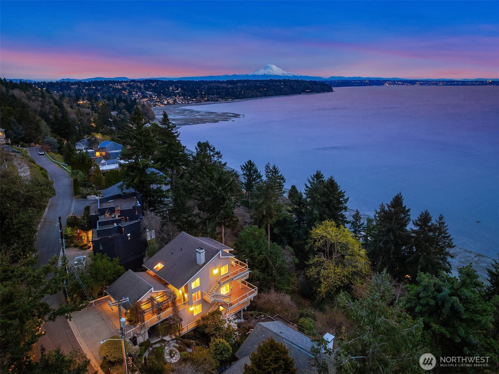 an aerial view of a house with a lake view