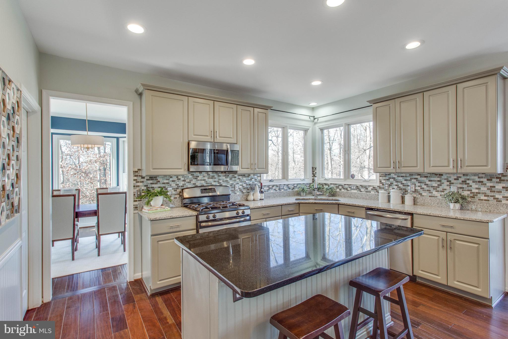 13230 Stable Brook Way Herndon, VA 20171 - Photo 10 of 47 and features granite counters, glass backsplash,