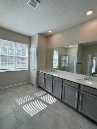a large bathroom with a sink a vanity and a mirror