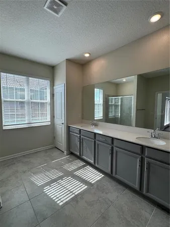 a bathroom with a sink vanity and mirror
