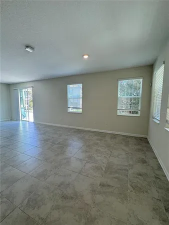 an empty room with windows and entrance