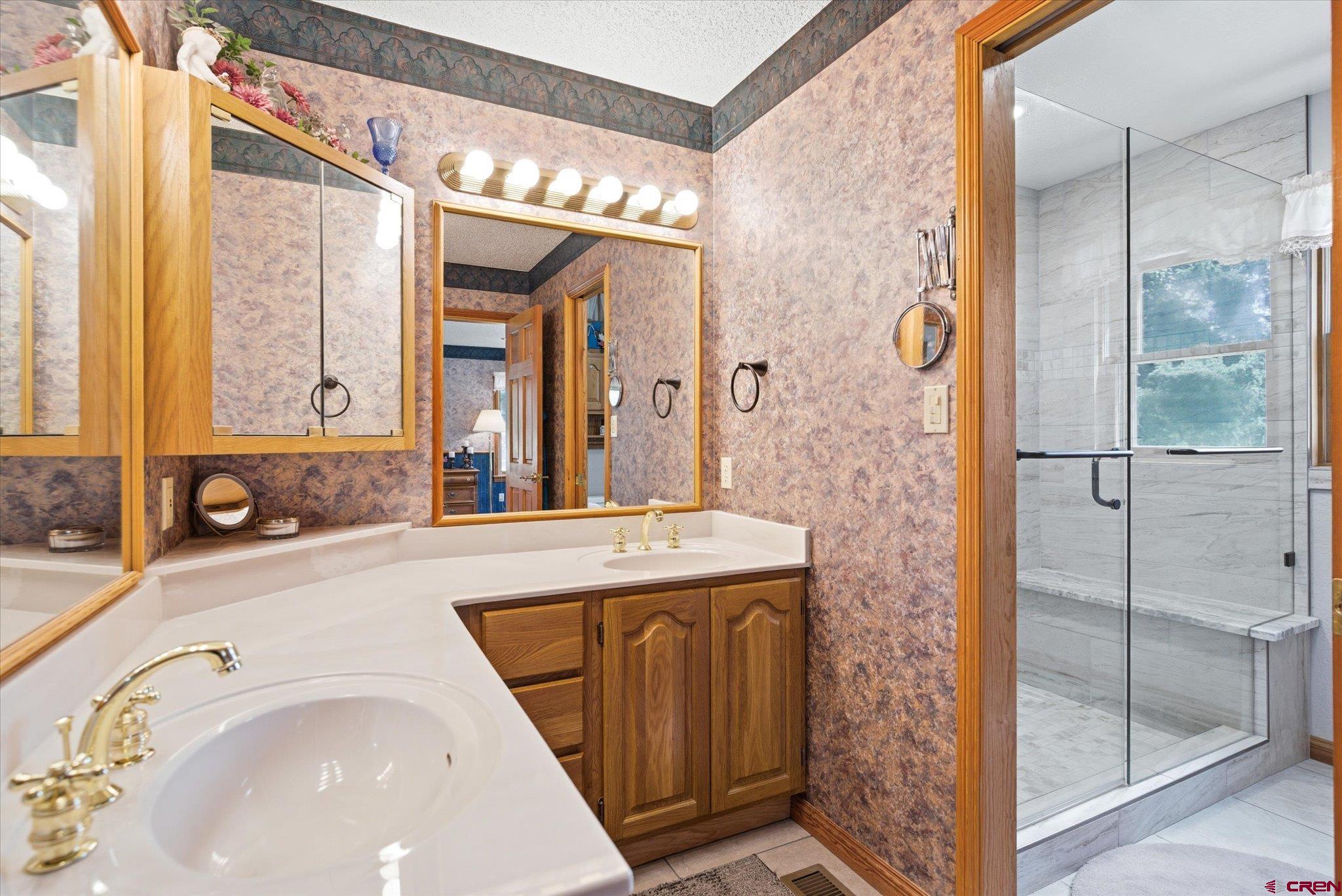 197 Hummingbird Way Bayfield, CO 81122 - Photo 17 of 44 a bathroom with a tub sink and mirror