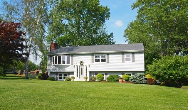 a front view of a house with a garden