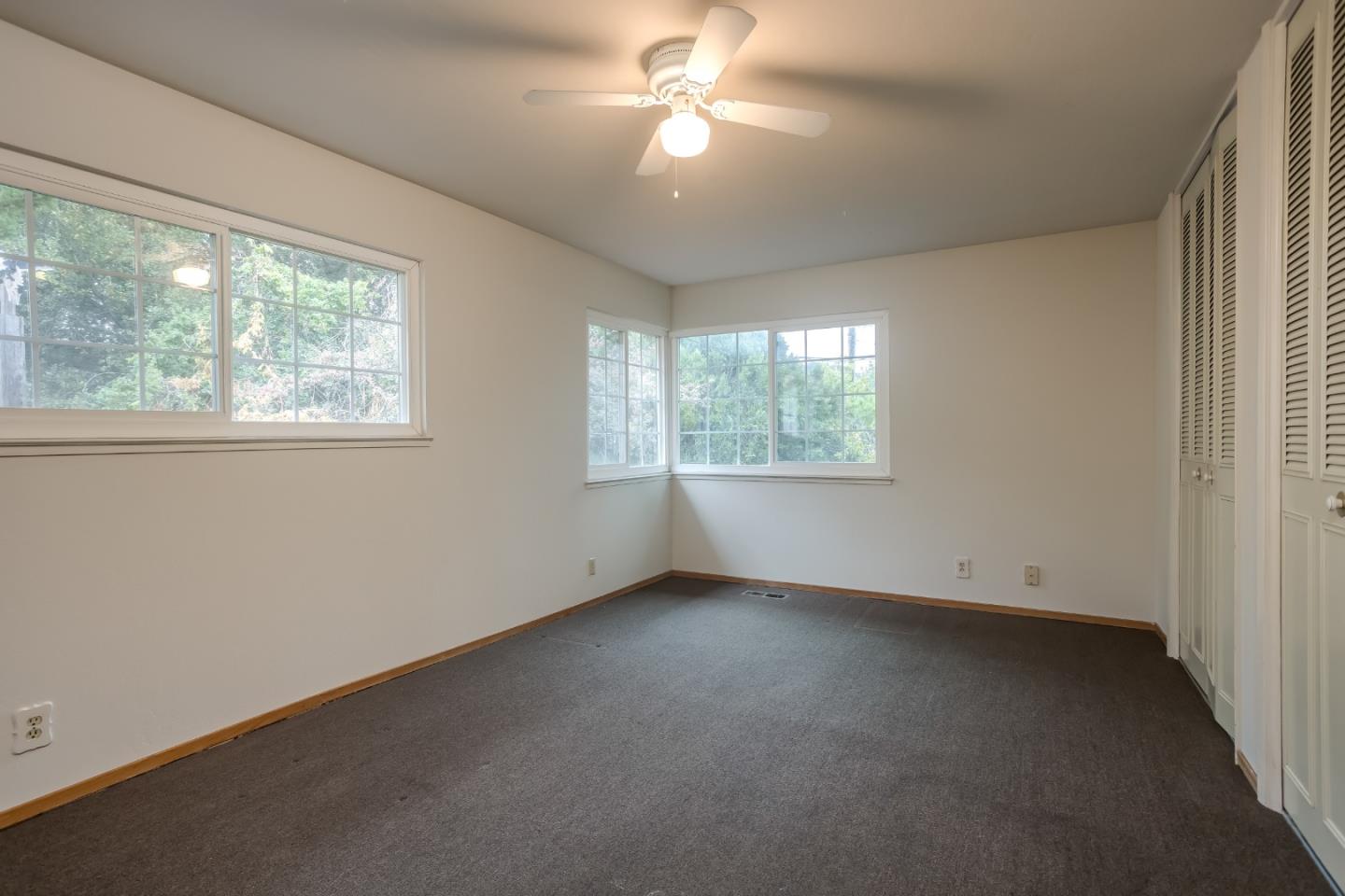 22381 McClellan Road Cupertino, CA 95014 - Photo 8 of 14 an empty room with a window and a fan