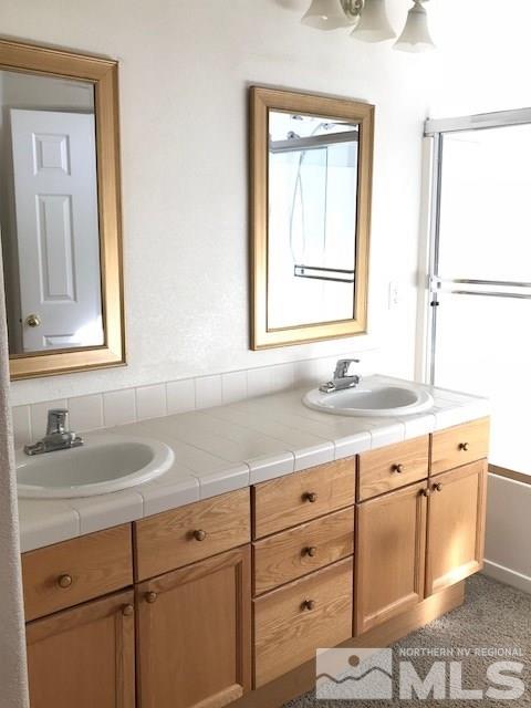 10575 Arbor Way Reno, NV 89521 - Photo 11 of 19 a bathroom with a granite countertop sink mirror and