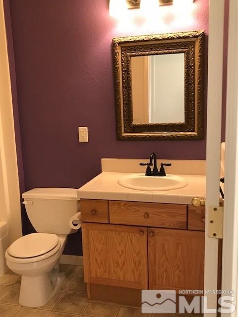10575 Arbor Way Reno, NV 89521 - Photo 13 of 19 a bathroom with a toilet a sink and mirror
