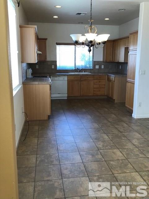 10575 Arbor Way Reno, NV 89521 - Photo 2 of 19 a kitchen with kitchen island granite countertop a sink cabinets and window