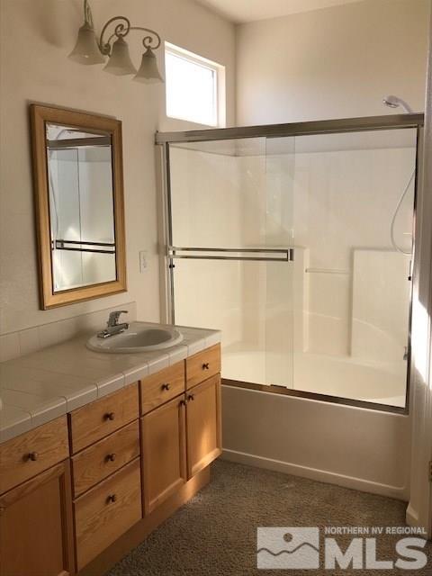 10575 Arbor Way Reno, NV 89521 - Photo 10 of 19 a bathroom with a granite countertop sink a mirror and a shower