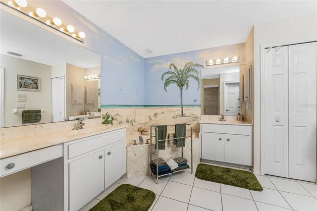 a spacious bathroom with a sink and a mirror