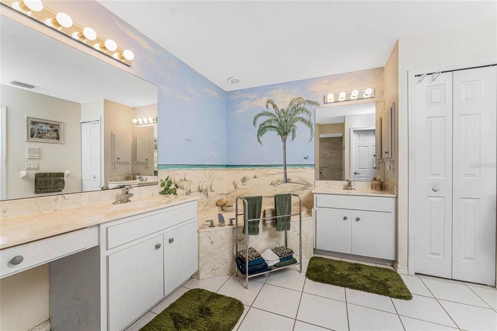 20 Long Meadow Place Rotonda West, FL 33947 - Photo 21 of 48 a spacious bathroom with a double vanity sink a mirror and a shower