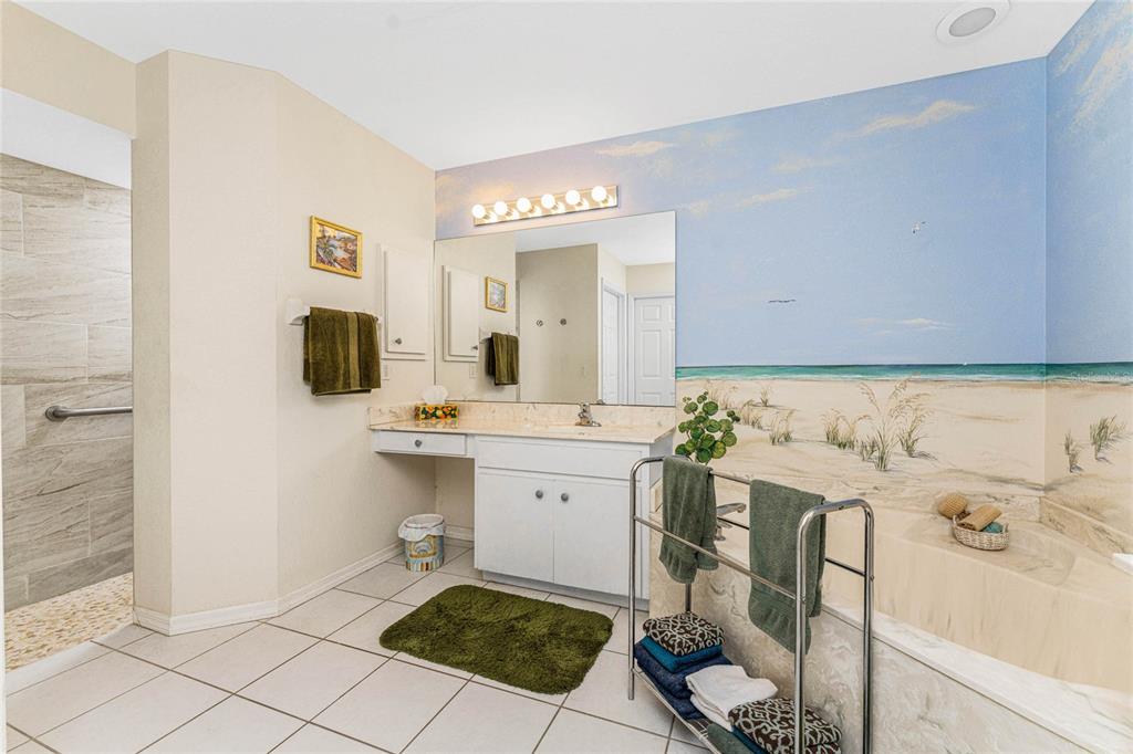 20 Long Meadow Place Rotonda West, FL 33947 - Photo 22 of 48 a spacious bathroom with a sink and a mirror