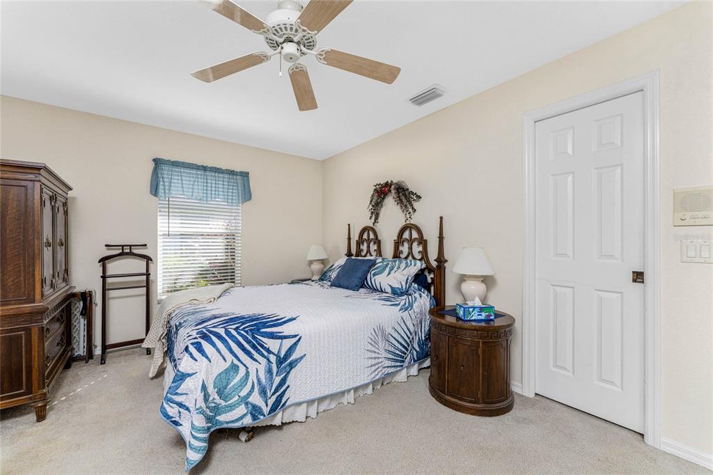 20 Long Meadow Place Rotonda West, FL 33947 - Photo 23 of 48 a bedroom with a bed and a chandelier