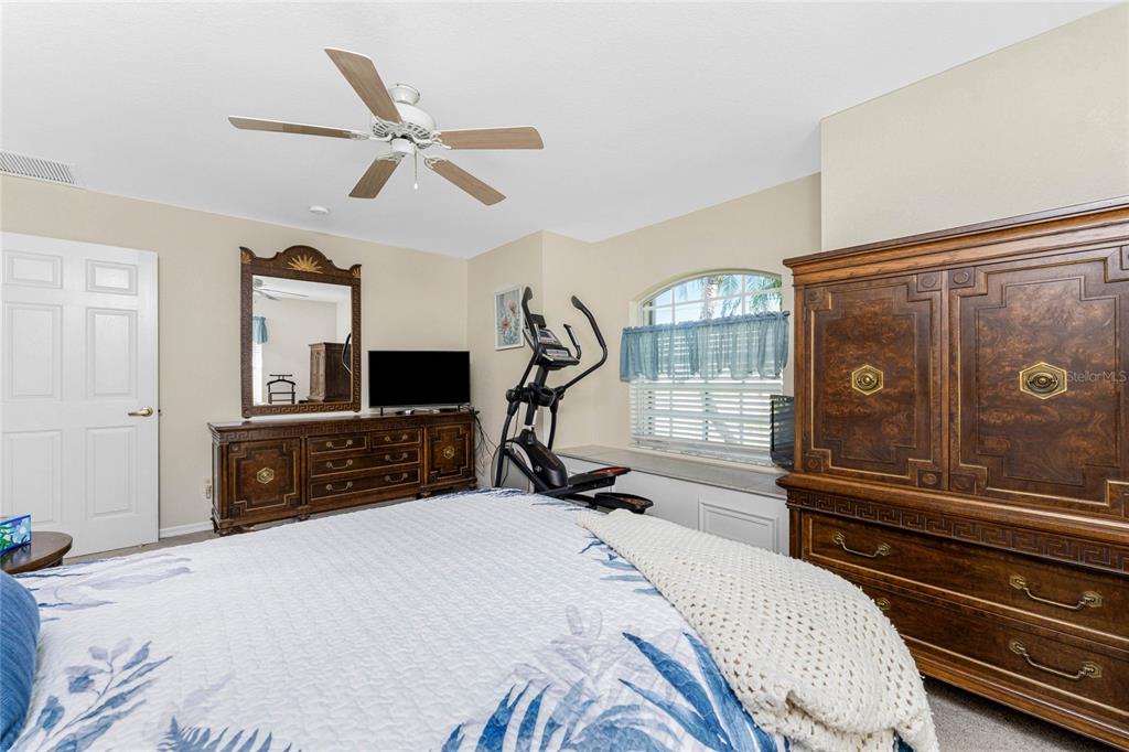 20 Long Meadow Place Rotonda West, FL 33947 - Photo 24 of 48 a bedroom with a bed and a flat tv screen on dresser