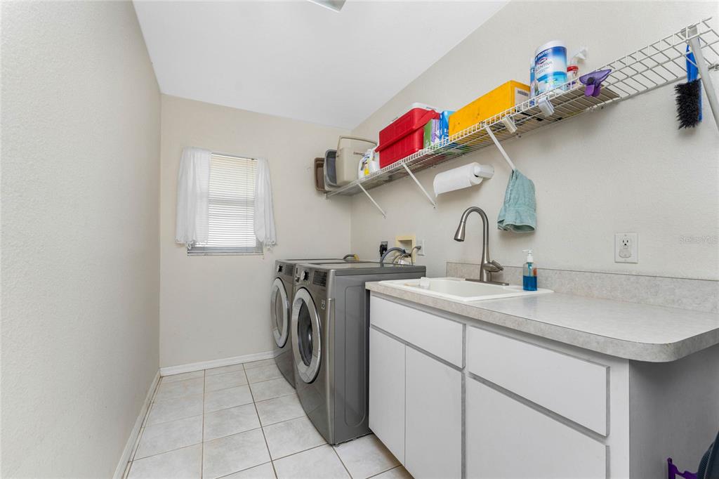 20 Long Meadow Place Rotonda West, FL 33947 - Photo 29 of 48 a utility room with sink dryer and washer