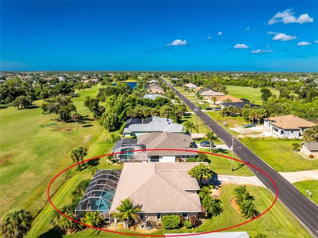 a view of a house with a yard and a tree