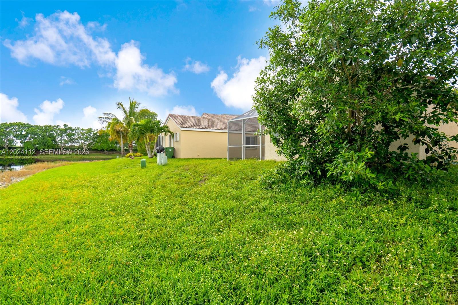 4366 Mahogany Ridge Drive Weston, FL 33331 - Photo 25 of 41 a backyard of a house with lots of green space and fountain