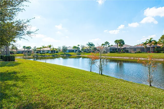 a view of a lake with houses in the back