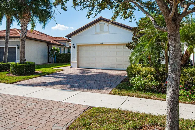 a front view of a house with a yard and garage