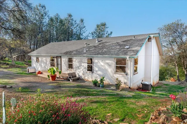 a front view of house with yard and outdoor seating