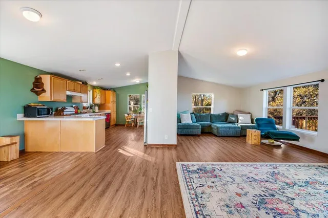 a living room with furniture and a wooden floor