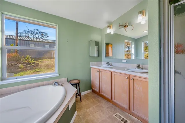 a bathroom with a tub and toilet