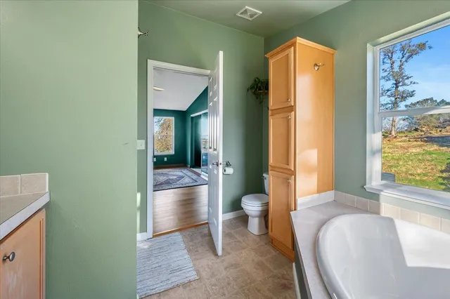 a view of a workspace with furniture and wooden floor