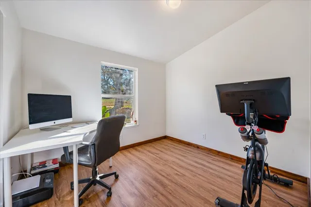 a roof deck with wooden floor and fence