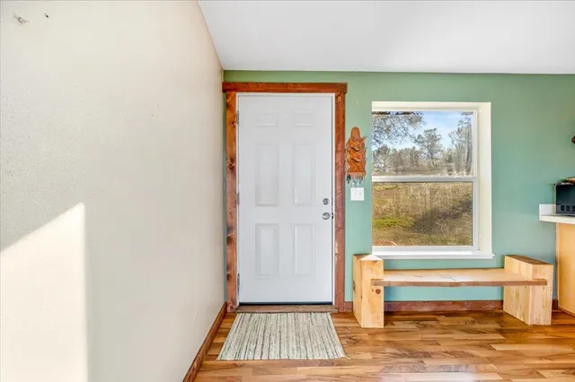 a view of a livingroom with furniture hardwood floor and a ceiling fan