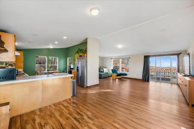 a kitchen with sink a stove and wooden floor