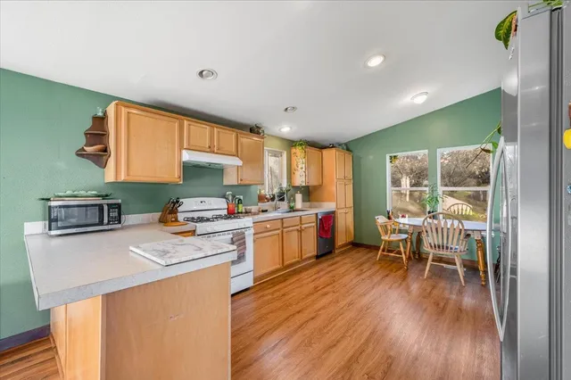 a kitchen with a sink stove and cabinets