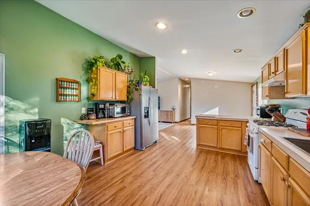 a large kitchen with a stove a sink dishwasher and a refrigerator