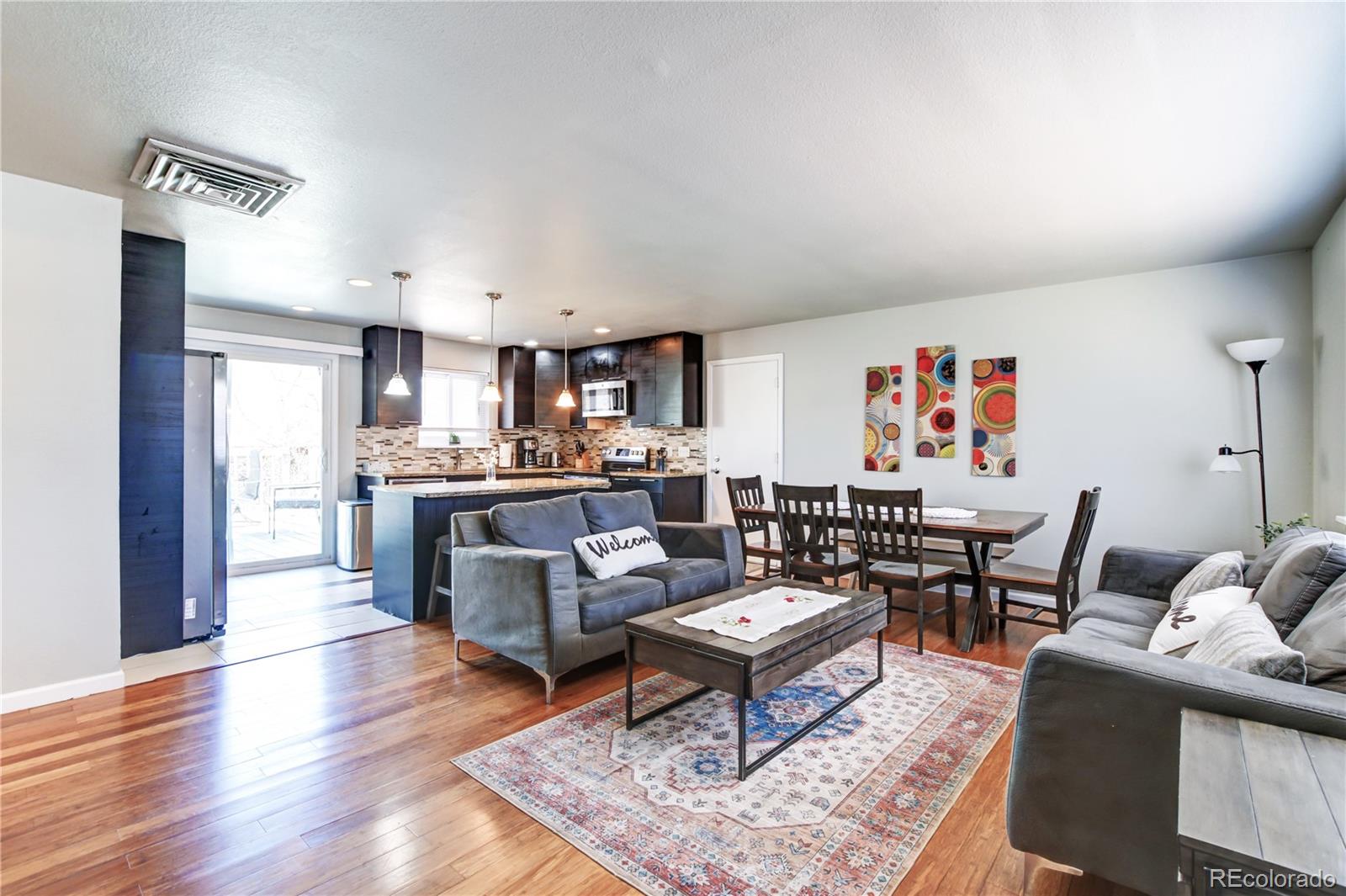 a living room with furniture kitchen view and a table