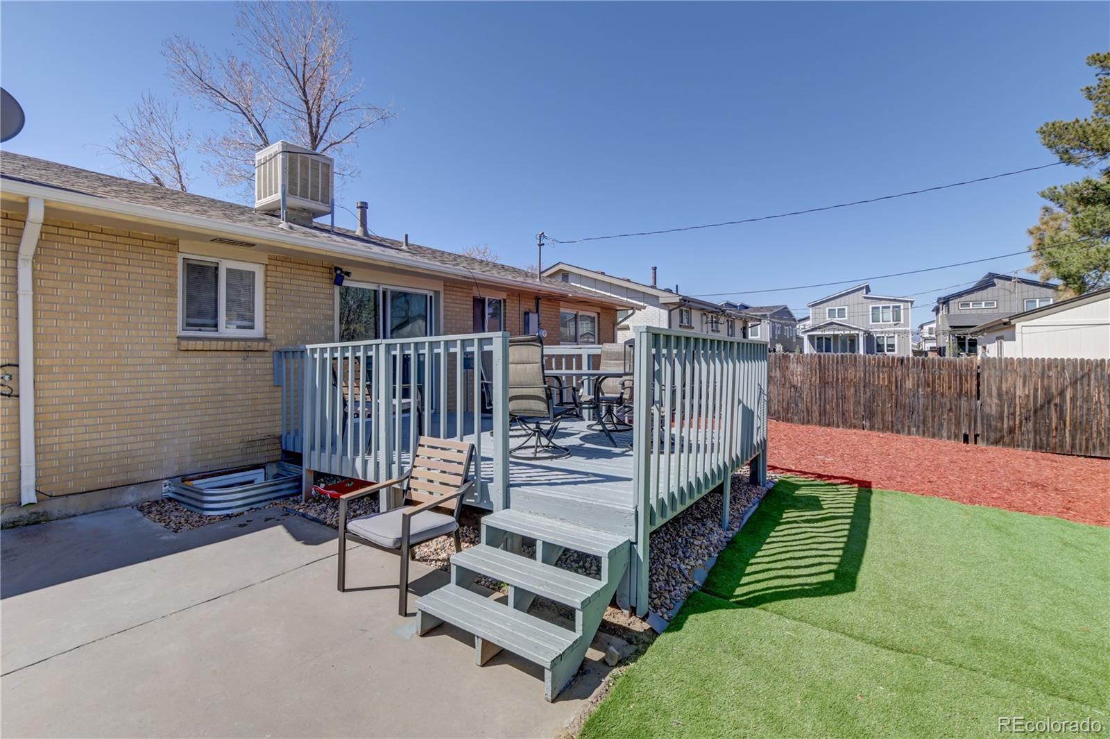 2361 West 57th Avenue Denver, CO 80221 - Photo 14 of 15 a view of a backyard with wooden floor and iron fence