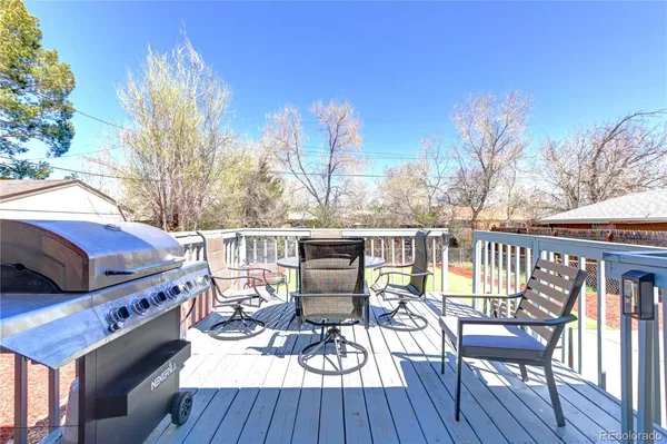 a view of a balcony with wooden floor and outdoor seating