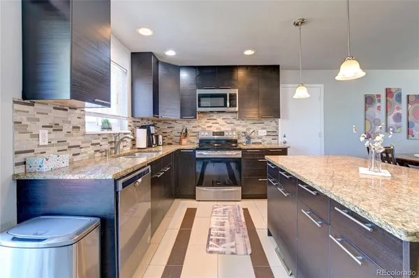 a kitchen with a sink stove top oven and microwave