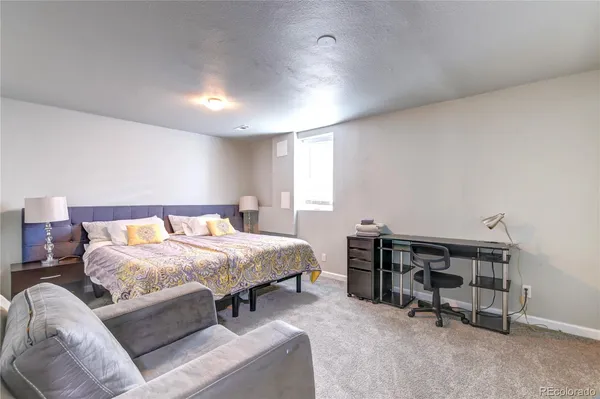 a bed room with a bed and a chair