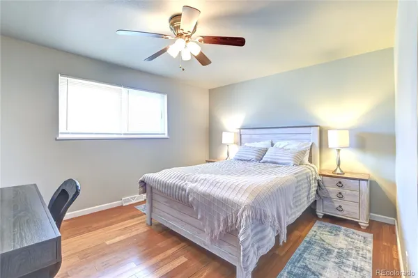 a bedroom with a bed a chandelier and a chair