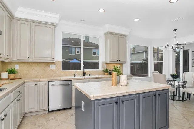a kitchen with a sink stove and cabinets